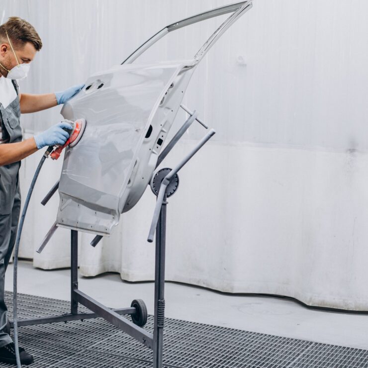 car-mechanic-polishing-car-before-painting