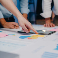 Millennial Asia businessmen and businesswomen meeting brainstorm Millennial Asia businessmen and businesswomen meeting brainstorming ideas about new paperwork project colleagues working together planning success strategy enjoy teamwork in small modern night office.